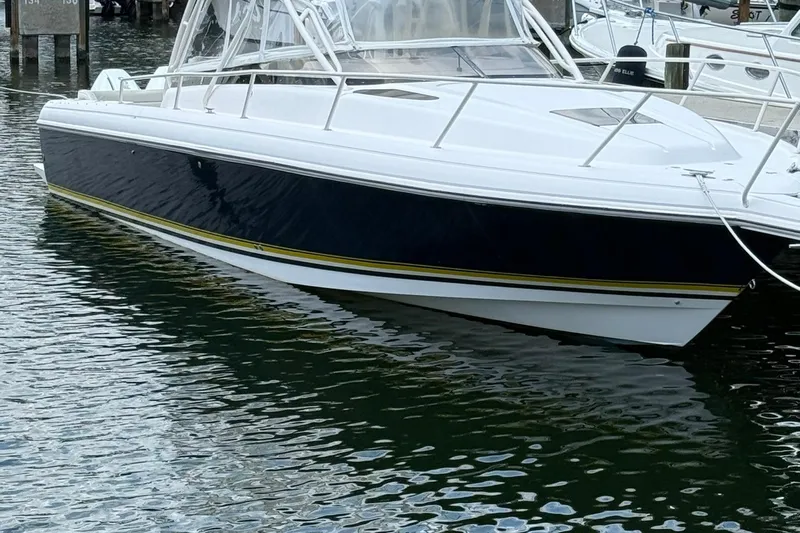  Yacht Photos Pics 2006 Intrepid 377 boat docked in marina, featuring sleek design and white hull.