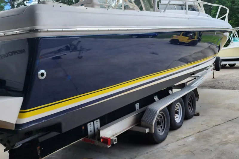  Yacht Photos Pics 2006 Intrepid 377 boat on trailer, featuring sleek design and yellow stripe.