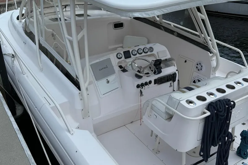  Yacht Photos Pics 2006 Intrepid 377 boat cockpit with steering wheel and control panel.