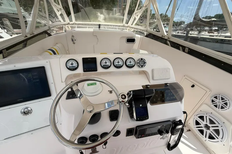  Yacht Photos Pics 2006 Intrepid 377 boat cockpit with steering wheel, gauges, and navigation equipment.