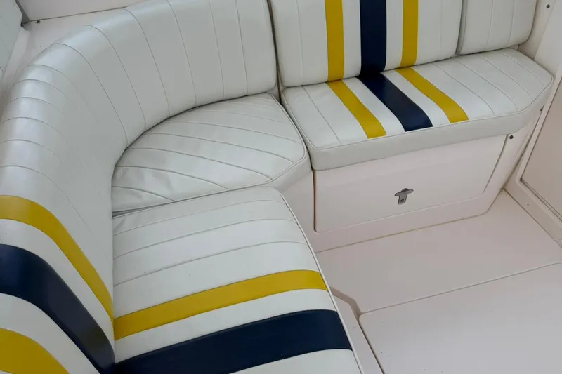  Yacht Photos Pics White boat seating with yellow and blue stripes, Intrepid 377, 2006 model.