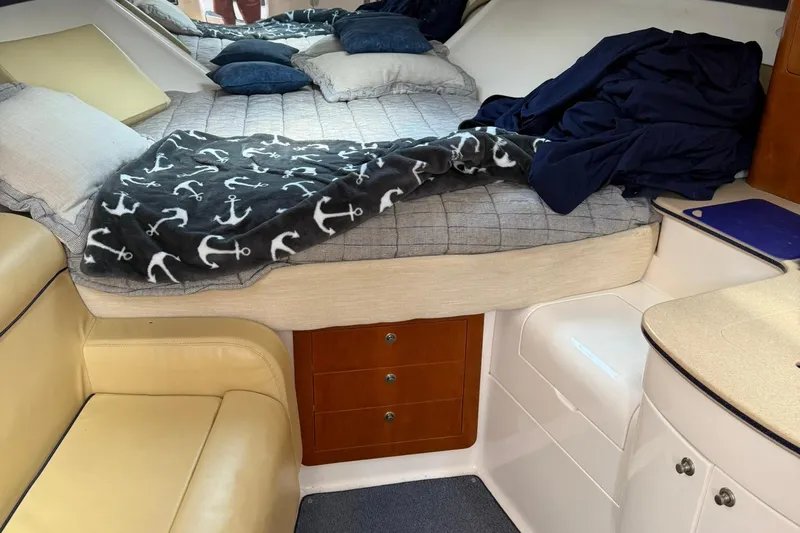  Yacht Photos Pics Cozy cabin interior of 2006 Intrepid 377 with bed, anchor blanket, and seating.