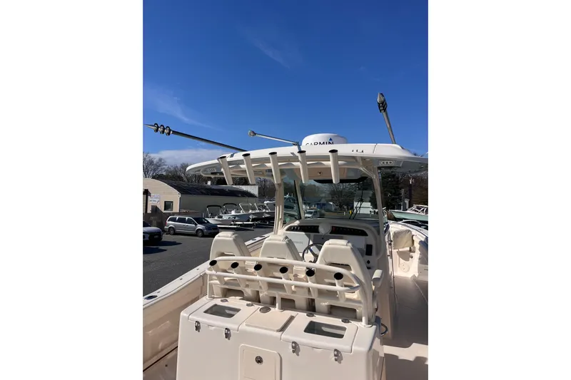  Yacht Photos Pics 2022 Grady-White Canyon 336 boat with advanced navigation equipment under clear blue sky.