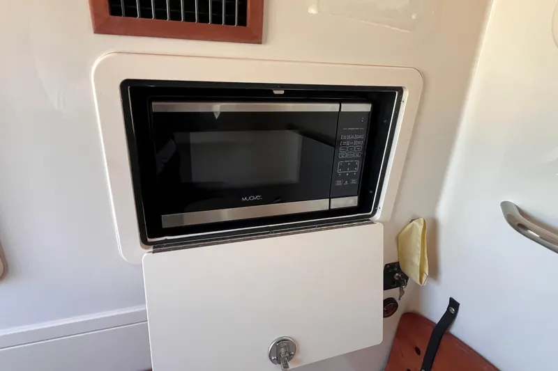  Yacht Photos Pics Built-in microwave on 2022 Grady-White Canyon 336 boat interior.