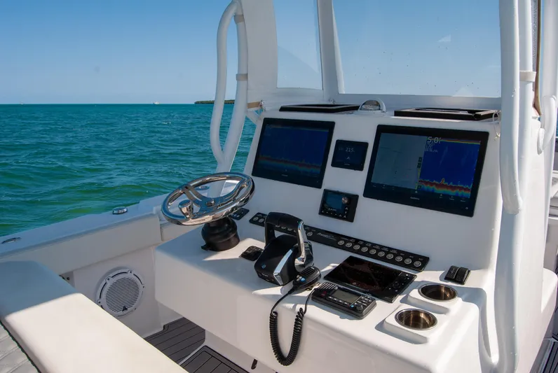  Yacht Photos Pics 2023 Front Runner 33 Center Console boat dashboard with navigation screens and steering wheel.