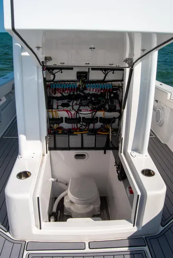  Yacht Photos Pics 2023 Front Runner 33 Center Console boat with open console showing wiring and marine toilet.