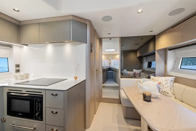 V50 Open Yacht Photos Pics Luxurious interior of 2026 Princess V50 Open yacht with modern kitchen and cozy seating area.