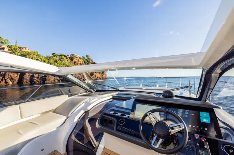 V50 Open Yacht Photos Pics Interior view of 2026 Princess V50 Open yacht, featuring modern dashboard and ocean backdrop.