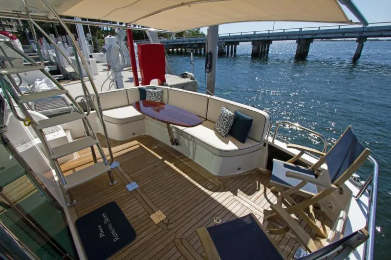 Ohana Yacht Photos Pics 2016 Sabre Flybridge yacht deck with seating, table, and ocean view.