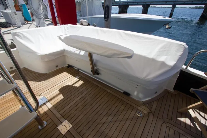 Ohana Yacht Photos Pics 2016 Sabre Flybridge yacht deck with covered seating and wooden flooring.
