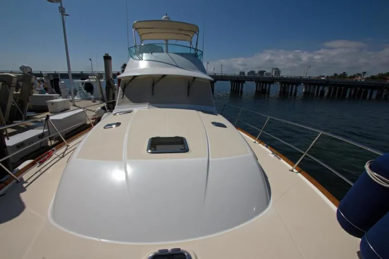 Ohana Yacht Photos Pics 2016 Sabre Flybridge yacht docked at marina, clear sky, calm water.