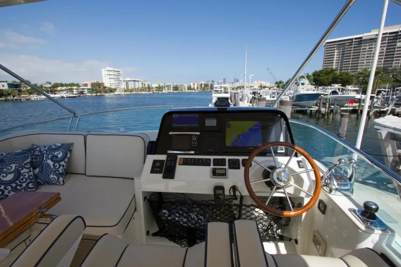 Ohana Yacht Photos Pics 2016 Sabre Flybridge yacht helm with scenic marina view.