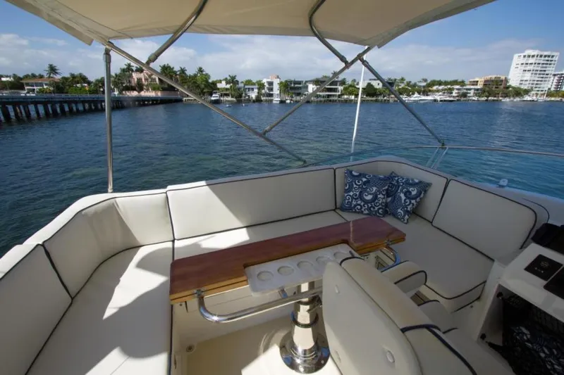 Ohana Yacht Photos Pics 2016 Sabre Flybridge yacht with spacious seating and scenic waterfront view.