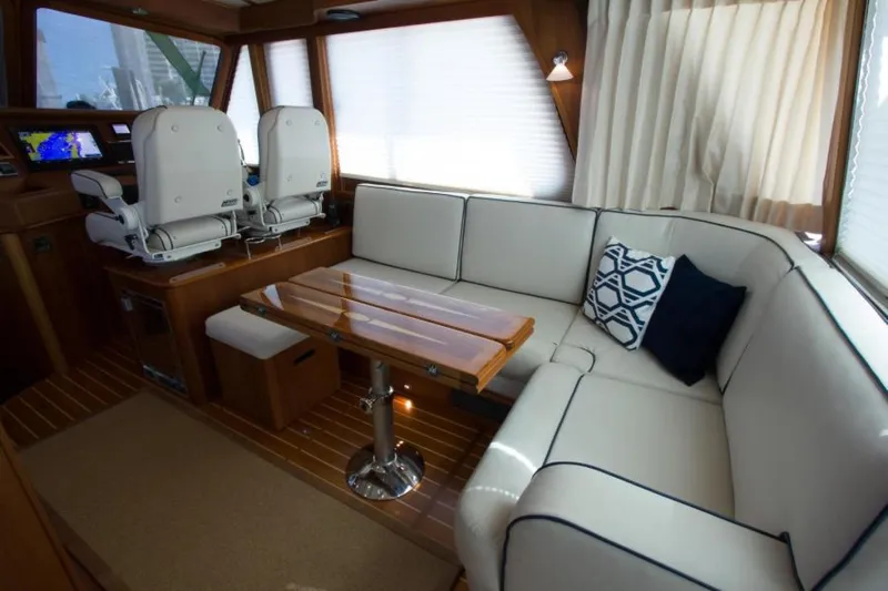 Ohana Yacht Photos Pics Luxurious 2016 Sabre Flybridge yacht interior with white seating and wooden accents.