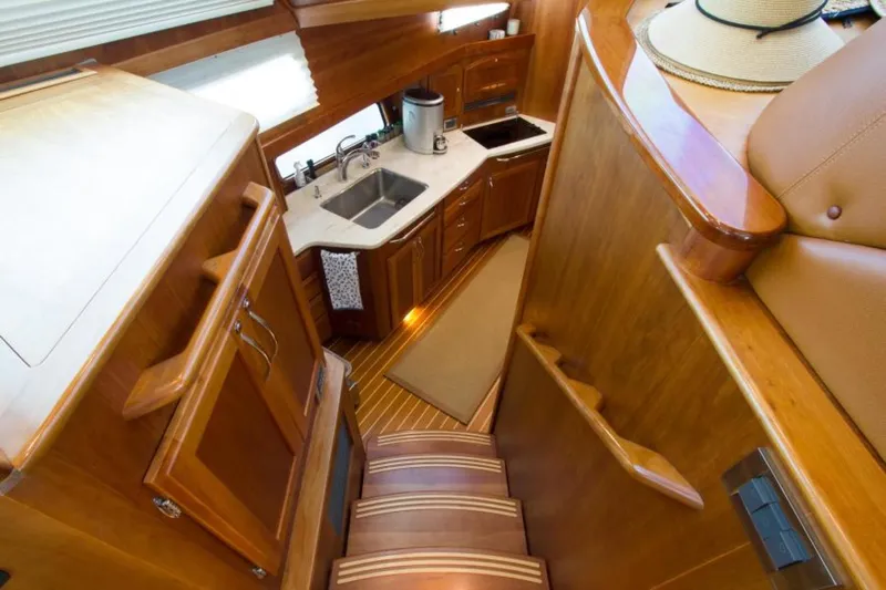 Ohana Yacht Photos Pics Luxurious 2016 Sabre Flybridge yacht interior with wooden cabinetry and modern kitchen amenities.