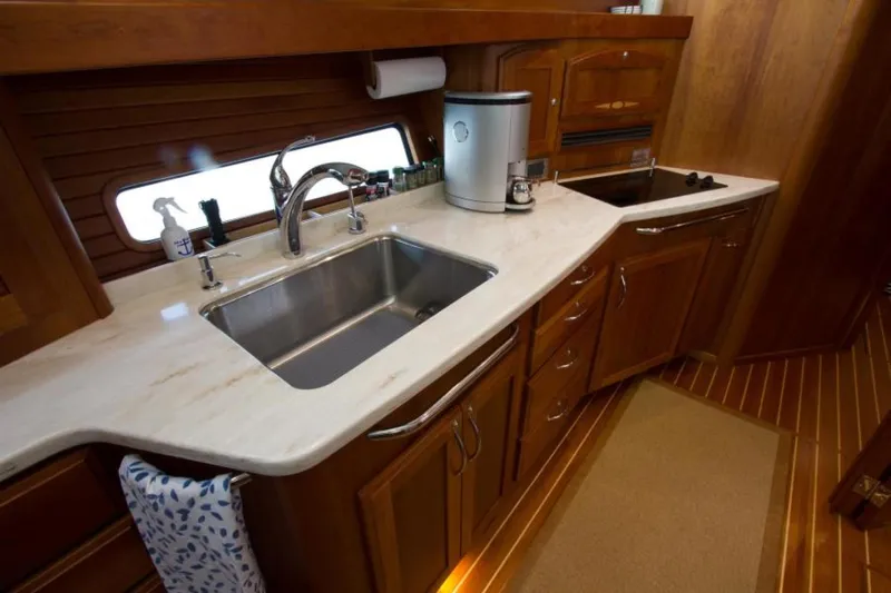 Ohana Yacht Photos Pics Luxurious 2016 Sabre Flybridge yacht kitchen with sleek countertops and stainless steel sink.