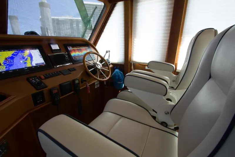 Ohana Yacht Photos Pics Interior of 2016 Sabre Flybridge yacht with navigation equipment and plush seating.
