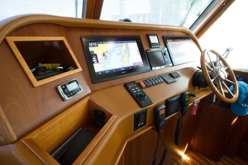 Ohana Yacht Photos Pics 2016 Sabre Flybridge helm with navigation screens and controls.