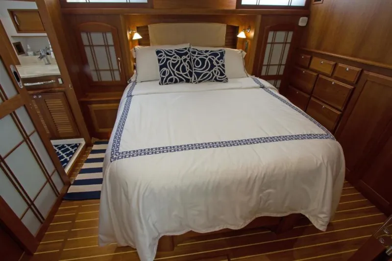 Ohana Yacht Photos Pics Luxurious 2016 Sabre Flybridge bedroom with elegant bedding and wooden interior.