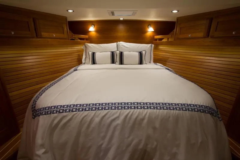 Ohana Yacht Photos Pics Luxurious 2016 Sabre Flybridge cabin with cozy bed and elegant wood paneling.