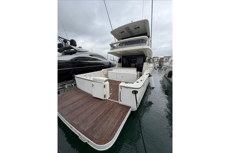  Yacht Photos Pics 2023 Maritimo M600 yacht with spacious deck, docked in marina.