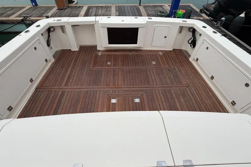  Yacht Photos Pics 2023 Maritimo M600 yacht deck with elegant wood finish and storage compartments.