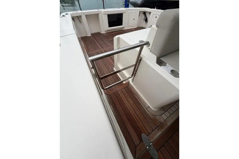  Yacht Photos Pics 2023 Maritimo M600 yacht deck with wooden flooring and stainless steel railing.