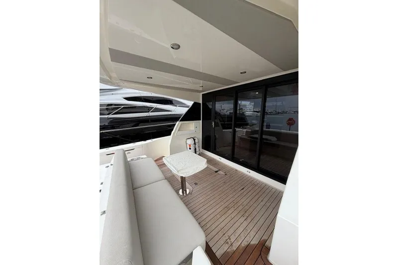  Yacht Photos Pics 2023 Maritimo M600 yacht deck with seating and table, featuring sleek design.
