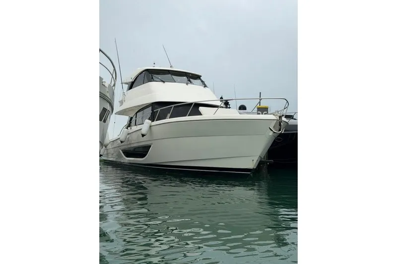  Yacht Photos Pics 2023 Maritimo M600 yacht docked in calm waters, showcasing sleek design and modern features.