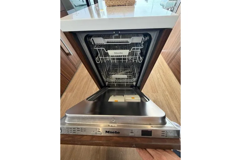  Yacht Photos Pics Open Miele dishwasher inside 2023 Maritimo M600 yacht kitchen.