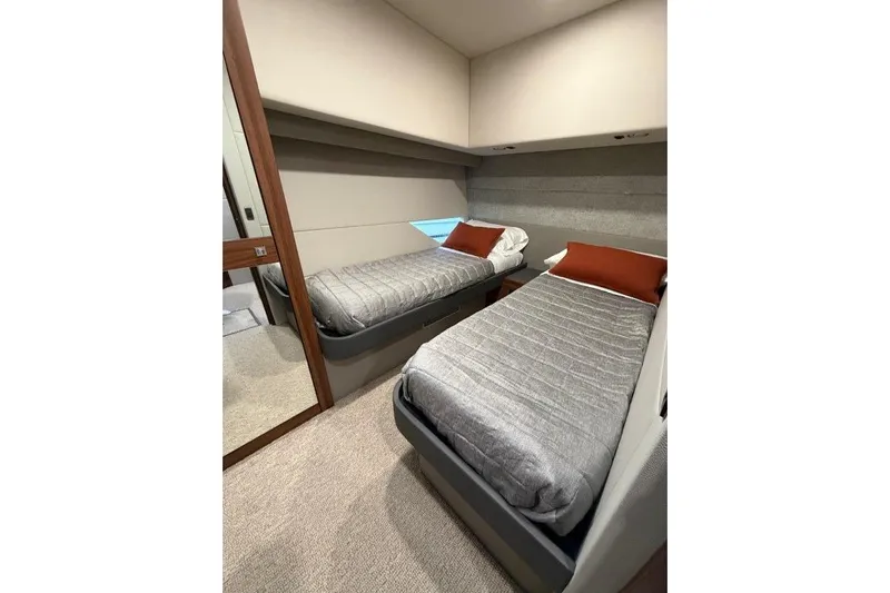  Yacht Photos Pics 2023 Maritimo M600 yacht cabin with twin beds and modern decor.