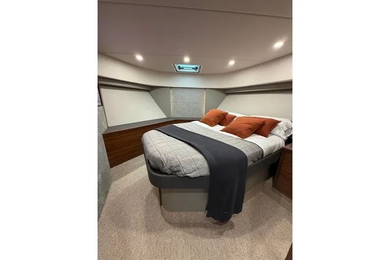  Yacht Photos Pics Luxurious bedroom interior of 2023 Maritimo M600 yacht with cozy bedding and ambient lighting.