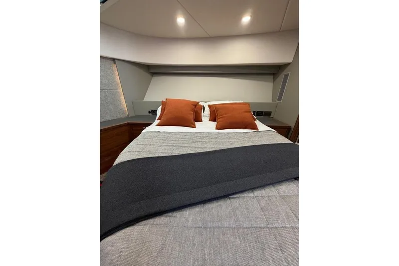  Yacht Photos Pics Luxurious 2023 Maritimo M600 yacht bedroom with modern bedding and ambient lighting.