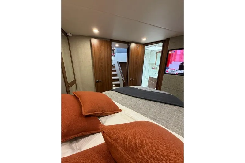  Yacht Photos Pics Luxurious bedroom interior of 2023 Maritimo M600 yacht with modern decor and TV.