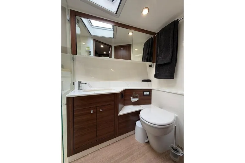  Yacht Photos Pics Luxurious bathroom in 2023 Maritimo M600 yacht with modern fixtures and wood accents.