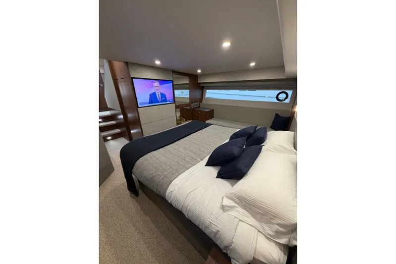  Yacht Photos Pics Luxurious bedroom interior of 2023 Maritimo M600 yacht with modern decor and TV.