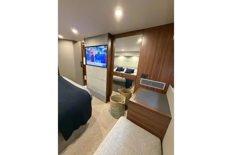 Yacht Photos Pics Luxurious interior of 2023 Maritimo M600 yacht with modern bedroom and TV.