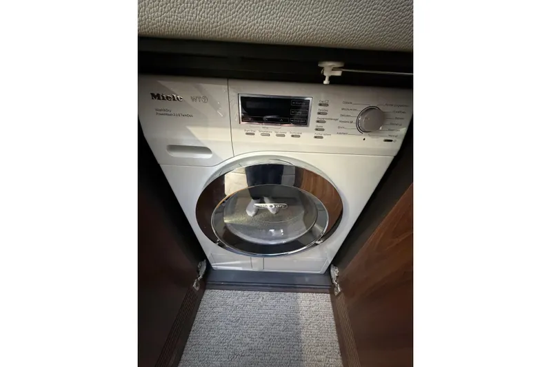  Yacht Photos Pics Miele washing machine inside 2023 Maritimo M600 yacht, compact and efficient design.