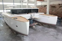 Catamaran Ocean Beast 65, 2020 model, in a shipyard, showcasing sleek design and modern features.