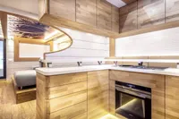 Luxurious interior of 2020 Catamaran Ocean Beast 65 with modern kitchen and wooden finishes.
