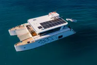 Ocean Beast 65 Catamaran, 2020 model, cruising on clear blue waters with solar panels.