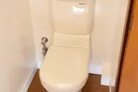 Toilet in Catamaran Ocean Beast 65, 2020 model, with wooden flooring.