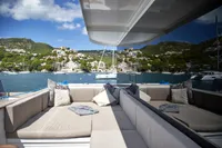 Luxurious Catamaran Ocean Beast 65, 2020 model, with scenic coastal view and plush seating.