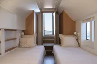 Twin cabin interior of 2020 Catamaran Ocean Beast 65 with ocean view.