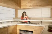 Woman enjoying coffee in modern kitchen of 2020 Catamaran Ocean Beast 65.