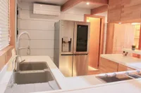 Modern kitchen interior on Catamaran Ocean Beast 65, featuring stainless steel appliances and sleek design.