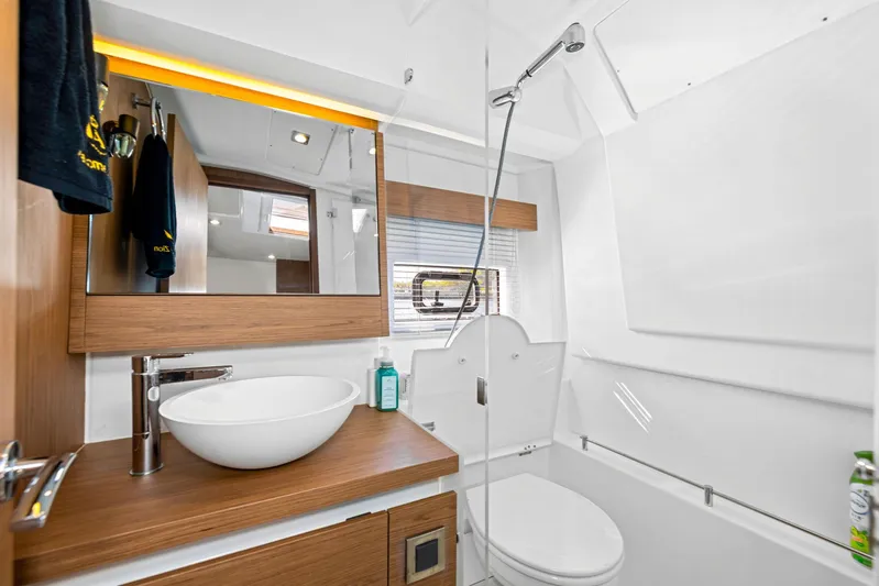  Yacht Photos Pics Modern bathroom in 2018 Jeanneau Leader 36 yacht with sleek fixtures and wood accents.