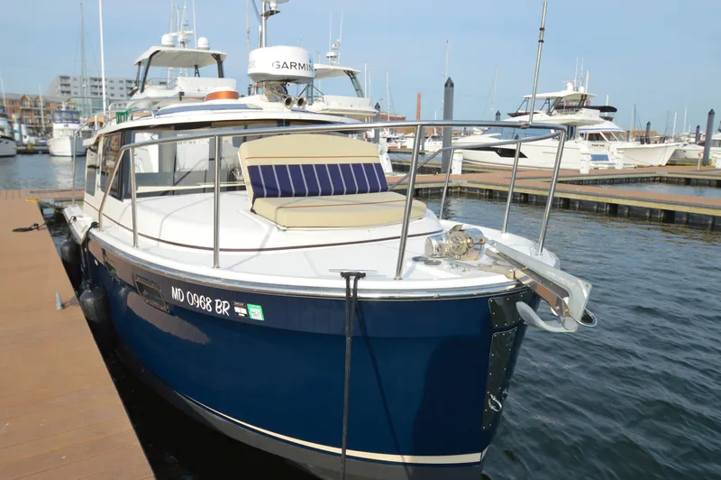 Chestnuts Yacht Photos Pics 2020 Ranger Tugs R-27 boat docked at marina, featuring blue hull and deck seating.