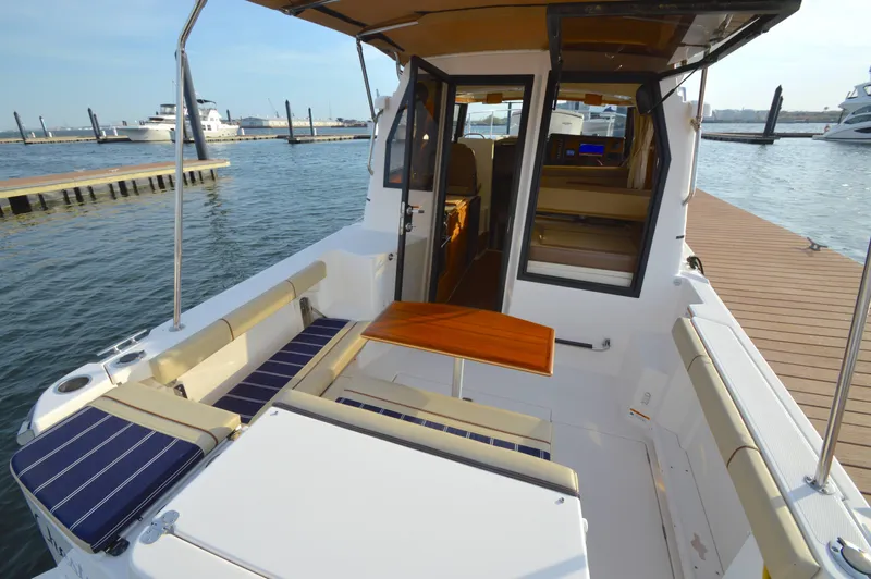 Chestnuts Yacht Photos Pics 2020 Ranger Tugs R-27 boat interior with seating and table at a marina dock.