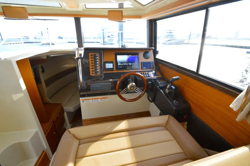 Chestnuts Yacht Photos Pics 2020 Ranger Tugs R-27 helm with modern navigation equipment and comfortable seating.
